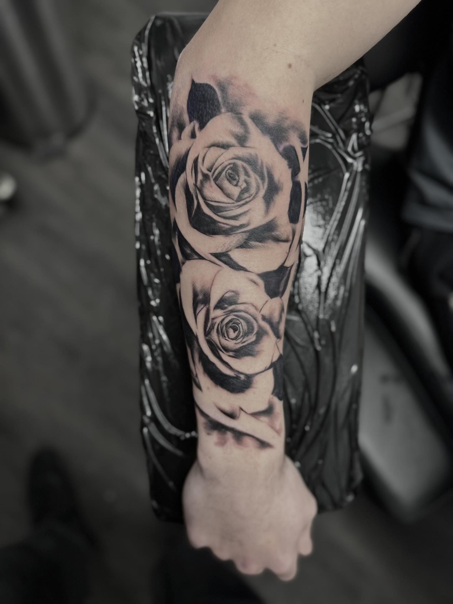 Black and grey roses on forearm