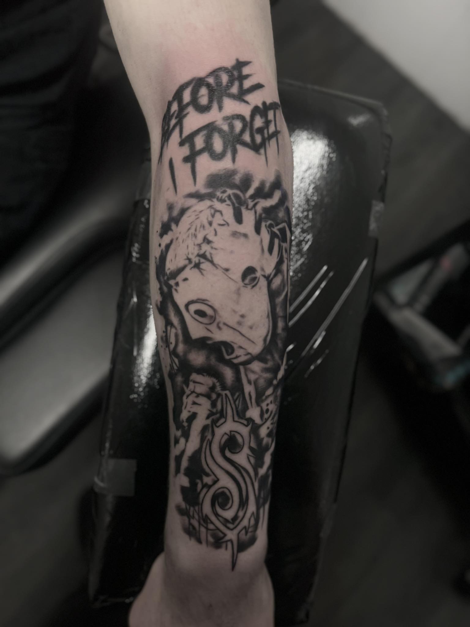 Slipknot mask forearm tattoo